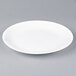A white Arcoroc Candour porcelain brunch plate on a gray surface.