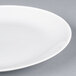 A close-up of a white Arcoroc Candour brunch plate with a rim.