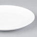An Arcoroc white porcelain B&B plate with a white rim.