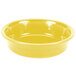 A yellow Fiesta bowl with a white background.