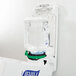 A Purell ADX hand sanitizer dispenser on a wall.