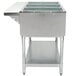 A stainless steel Eagle Group hot food table with glass top and shelves.