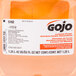 A bottle of GOJO FMX Luxury Orange Blossom Foaming Antibacterial Hand Soap on a counter with a label.