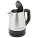 A Hamilton Beach stainless steel electric kettle with a black handle.