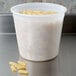A translucent plastic 5.25 quart deli container filled with pasta.