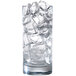 A glass filled with Manitowoc half size ice cubes.