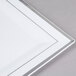 A white plastic square plate with silver trim.