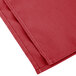 A red Intedge cloth napkin folded.