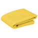A yellow folded 36" x 36" Intedge table cover.