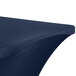 A navy blue Snap Drape Contour table cover on a table.