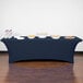 A navy blue Snap Drape spandex table cover on a table with food.