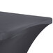 A charcoal Snap Drape Contour Table Cover with curved edges on a table.