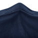 A close up of a navy blue spandex table cover.