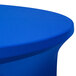 A royal blue spandex Snap Drape contour table cover on a round table.