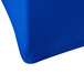 A royal blue spandex table cover on a round table.