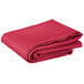 A folded hot pink Intedge cloth table cover.