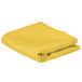 A yellow folded rectangular cloth table cover.