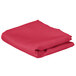 A folded hot pink rectangular cloth table cover.