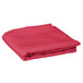 A folded hot pink Intedge table cover.
