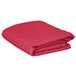 A folded hot pink fabric table cover.