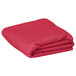 A folded hot pink rectangular table cover.