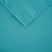 A teal square polyester cloth table cover with a hemmed edge.