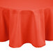 An Intedge orange 100% polyester round tablecloth on a table.