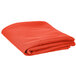 An orange hemmed Intedge table cover folded on a white background.