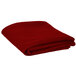 A folded red Intedge table cover on a white surface.