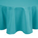 A teal round tablecloth on a round table.