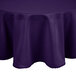 A purple Intedge 72" round polyester table cover on a table.