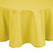 A yellow Intedge 90" round polyester tablecloth on a table.