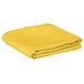 A yellow folded Intedge cloth table cover.