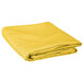 A folded yellow Intedge table cloth on a white background.