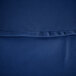 A close up of a royal blue hemmed cloth table cover with a small hole in it.