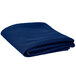 A folded royal blue Intedge round table cover.