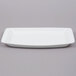 A white rectangular Arcoroc tray with a small rim.