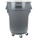 A grey plastic trash can with wheels.