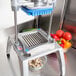 A Nemco Easy Chopper III blade and holder assembly with diced vegetables in the container.