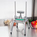 A Nemco Easy Chopper III vegetable dicer on a counter with vegetables in a bowl.