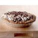 A chocolate pie with whipped cream on top in a D&W Fine Pack foil pie pan.