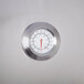A close-up of the stainless steel temperature gauge on a Backyard Pro roll dome lid.