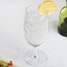 A Reserve by Libbey goblet with water and a lemon slice in it.