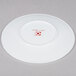 A white 10 Strawberry Street bone china plate with a red logo.