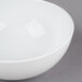 A 10 Strawberry Street white bone china cereal bowl with a small rim on a gray surface.