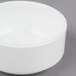 A 10 Strawberry Street white bone china bouillon bowl on a gray surface.