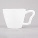 A white porcelain cappuccino cup with a white handle.