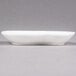 A white rectangular 10 Strawberry Street porcelain plate with curved edges.