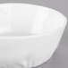 A 10 Strawberry Street bright white porcelain pinch bowl with a small rim on a gray surface.