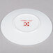 A white 10 Strawberry Street bone china plate with a red logo.